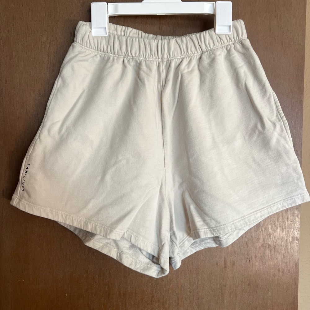 Shop TAN + LINES by Sivan high waisted cream shorts